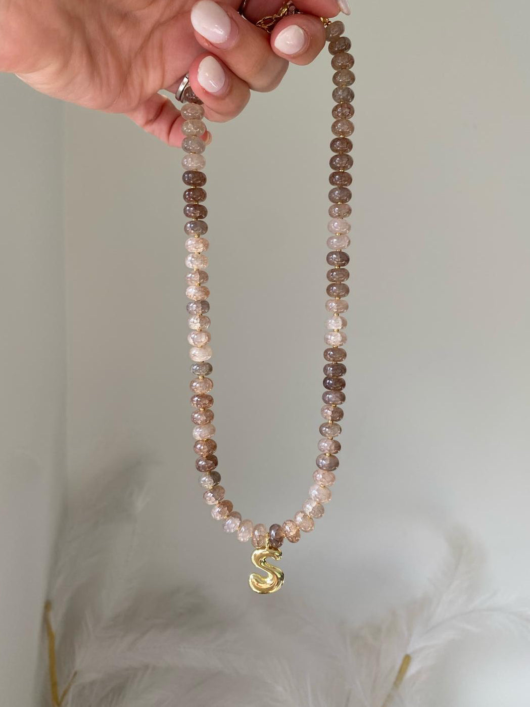 Beaded necklace with taupe, mocha, and champagne gemstone rondelle beads and a gold bubble letter S initial pendant