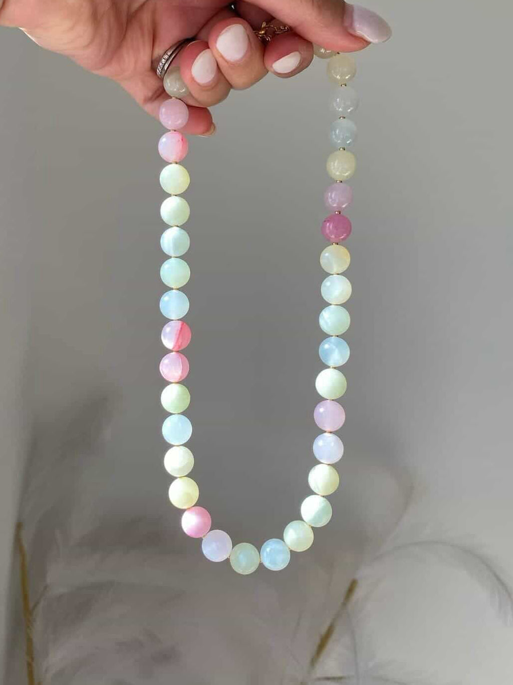 Beaded necklace with large smooth pastel gemstone beads in mint green, baby blue, blush pink, and lilac