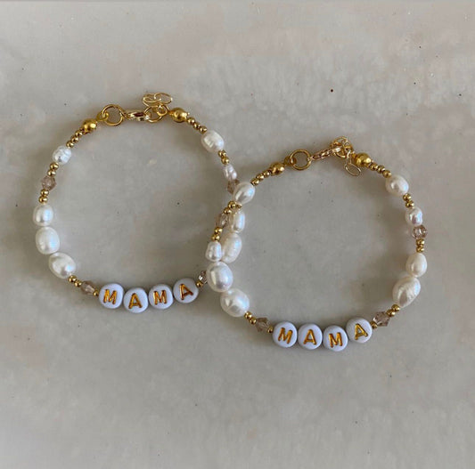 2 beaded bracelets of freshwater pearls, crystal beads and gold spacer beads, with white and gold letter beads spelling out "MAMA" 