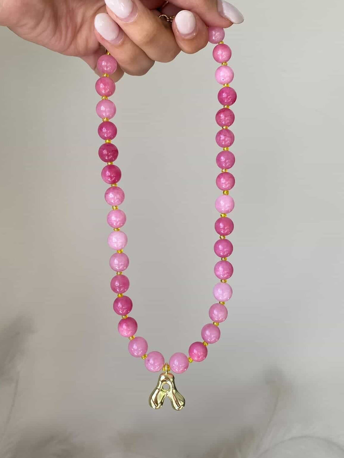The Vanessa necklace with a single gold bubble letter A charm