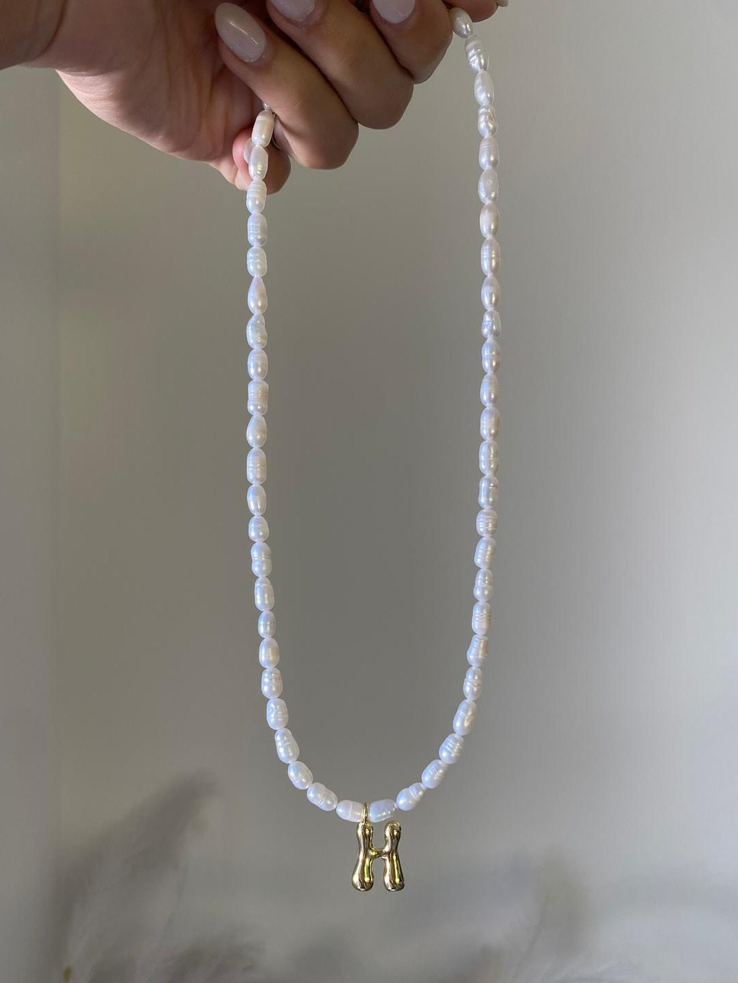 Perla necklace with a gold bubble letter H initial pendant
