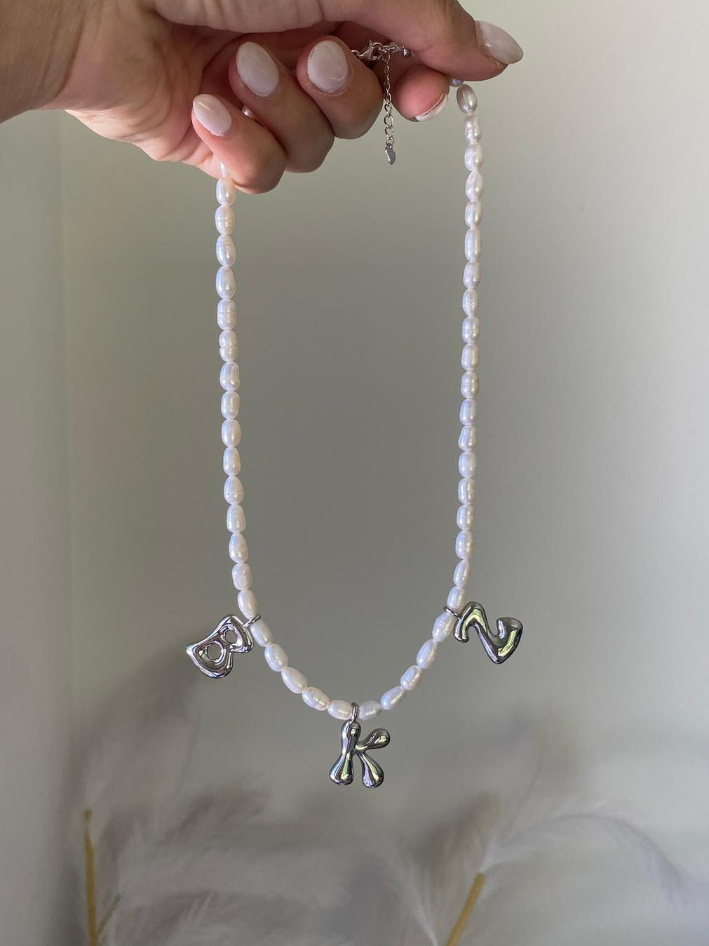 Perla necklace with three silver bubble initial charms spelling B, K, Z