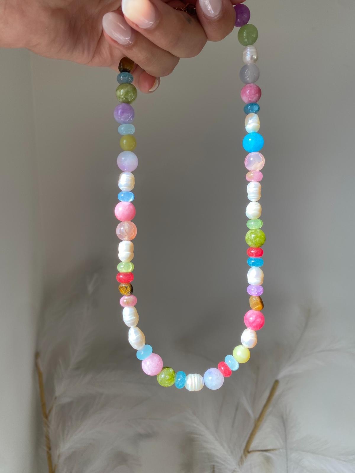 Beaded necklace with multicolour round gemstone beads and freshwater pearls in pink, blue, green, lilac, and tiger's eye