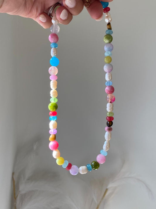 Beaded necklace with multicolour round gemstone beads and freshwater pearls in pink, blue, green, yellow, and lilac