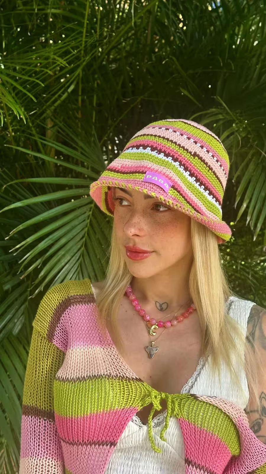 Customer wearing a customised pink beaded necklace layered with simple silver chain and pendant.